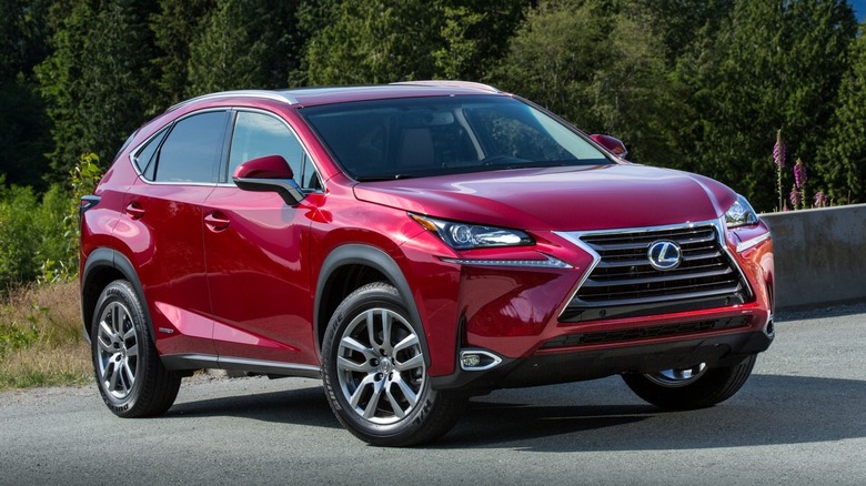 Lexus NX 300h parked on a road with trees in the background