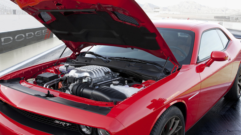 Red Dodge Challenger SRT Hellcat with engine showing