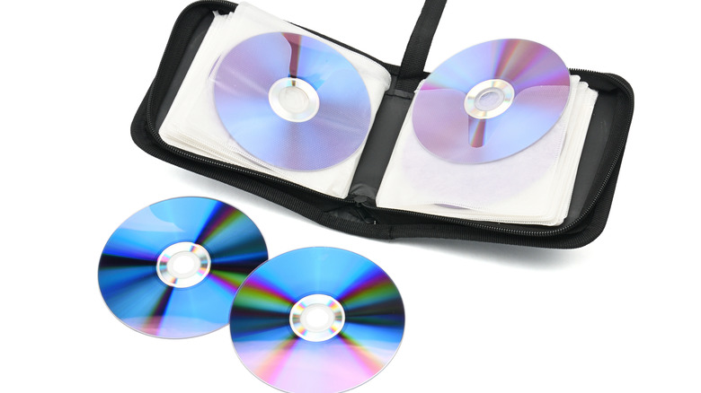 A CD Wallet With Compact Discs On A White Background