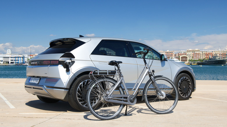 The Hyundai Ioniq 5 using its VTL to charge an electric bicycle