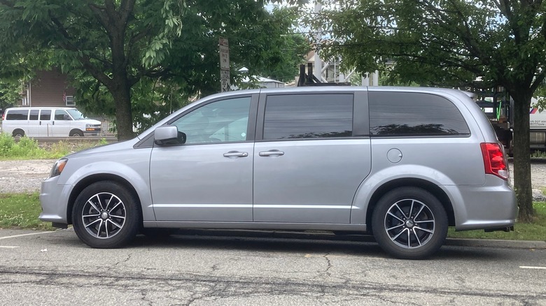 Minivan parked by trees