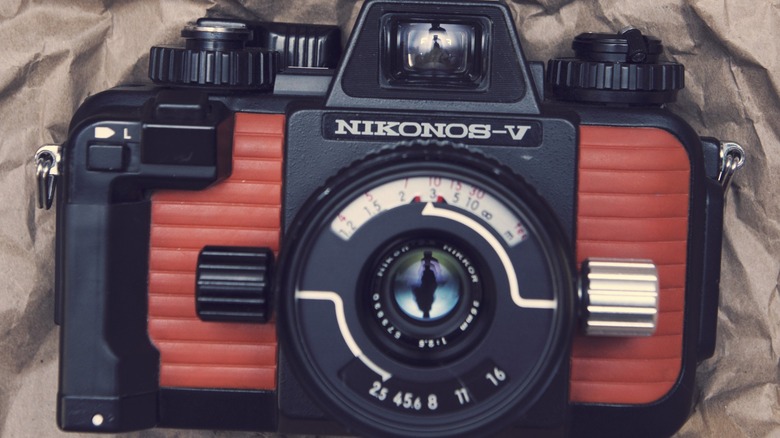 The Nikonos-V camera lying on a brown paper bag.