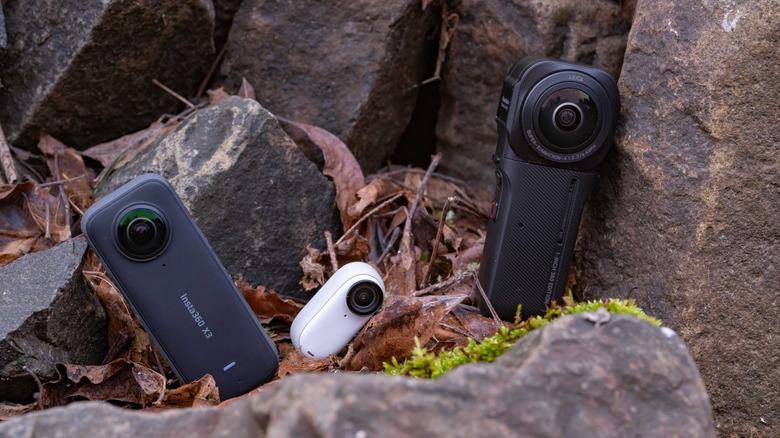 Three insta360 camera on a rock wall.