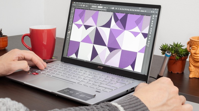 Laptop with Adobe Illustrator on screen