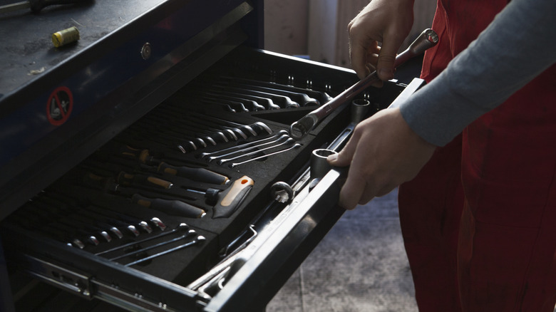 Mechanic using garage toolbox