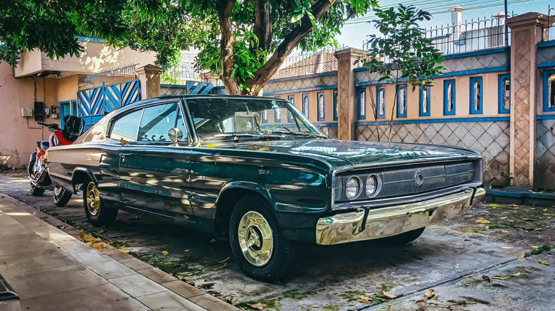 А 1966 first generation Dodge Charger, front 3/4 view, dark green