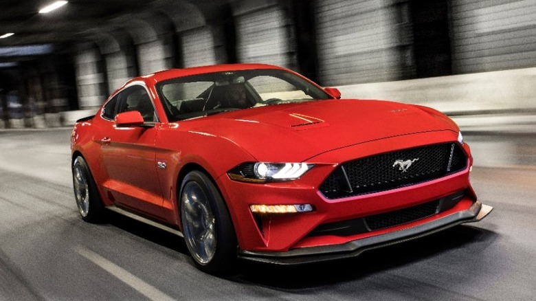 Red Mustang GT racing down tunnel