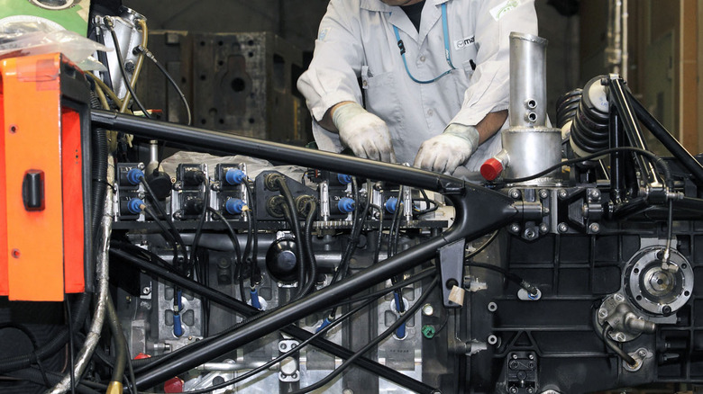 Technician works on R26B engine