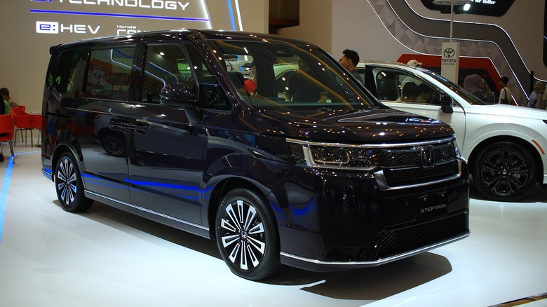 A black Honda Step WGN at an auto show in Indonesia, front 3/4 view