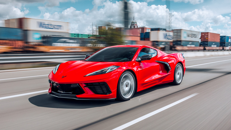 Red C8 Stingray racing down highway