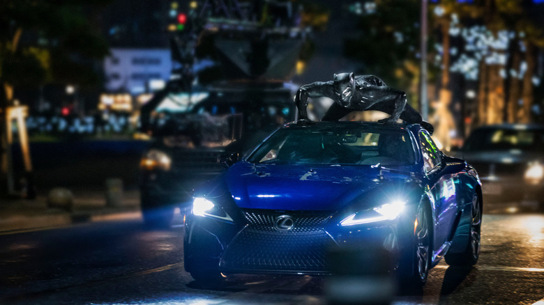 Lexus LC 500 with the Black Panther on top driving at speed front view