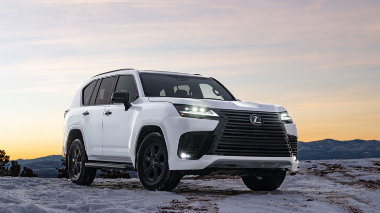 2025 Lexus LX 600parked on snow at sunset front 3/4 view