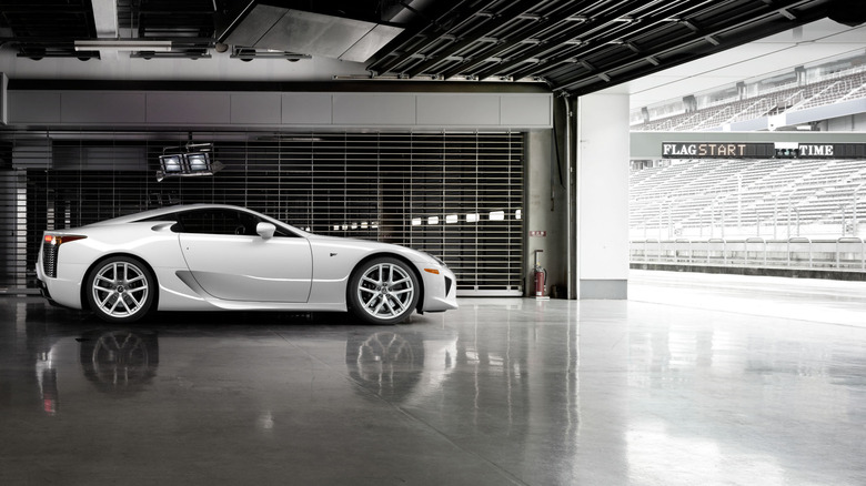 Lexus LFA parked in a pit garage on a race track, side view