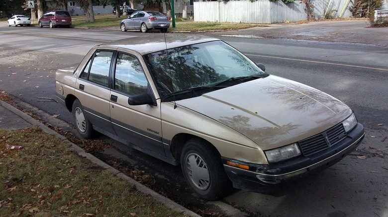 Tan fourth generation pontiac tempest parked on street