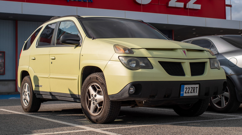 Pale green Pontiac Aztek in parking lot