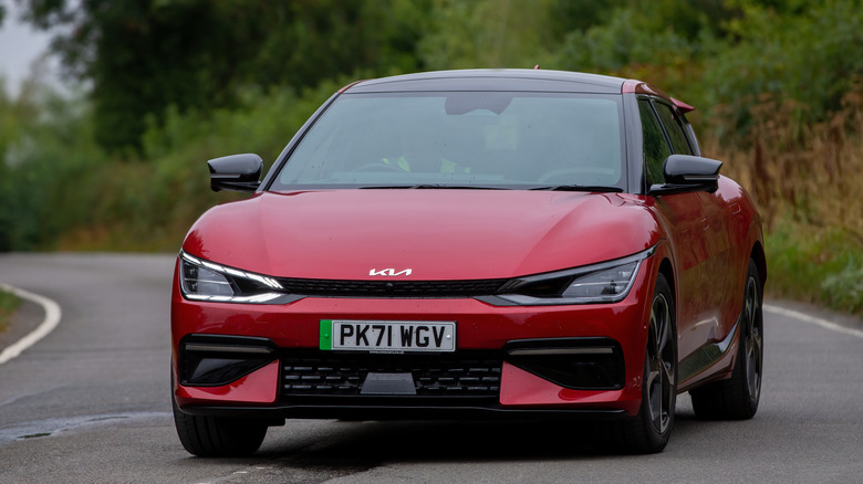 Red Kia EV6 driving on country road