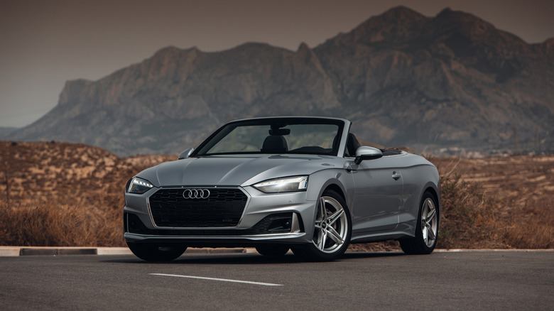 Silver audi a5 convertible in front of mountain range