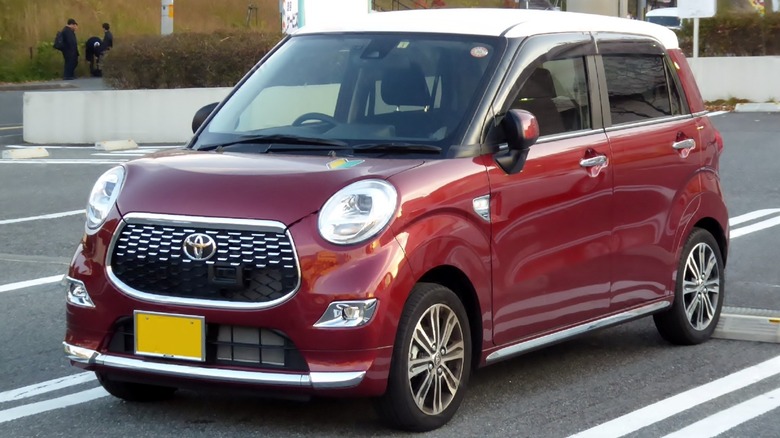 A red Toyota PIXIS JOY F G Turbo with a white roof, in a parking lot.