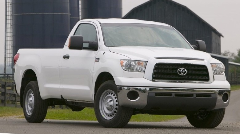 White 2008 Toyota Tundra Regular Cab parked on a paved surface with silos and a barn in the background