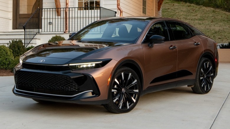 2023 Toyota Crown Platinum in Bronze Age with Black bi-tone parked on a pavement in front of a building