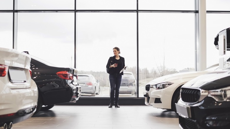 Woman standing in the middle of a dealership office