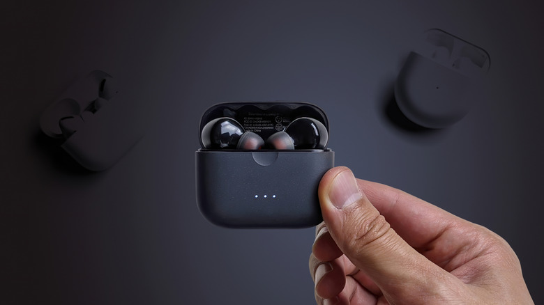 Man holds TWS wireless headphones Anker Soundcore Liberty Air 2 in a charging case