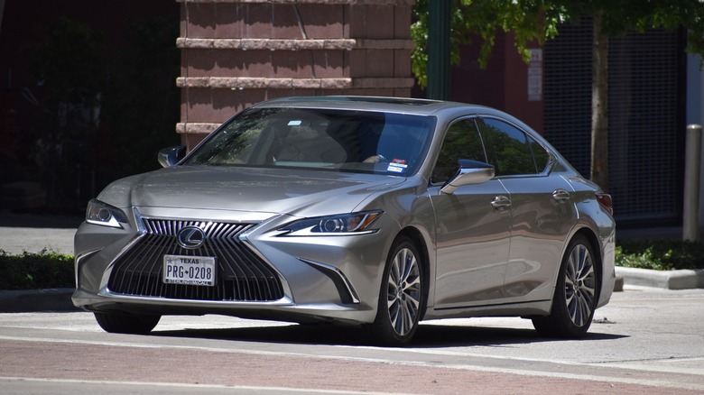 grey Lexus sedan cruising down a street