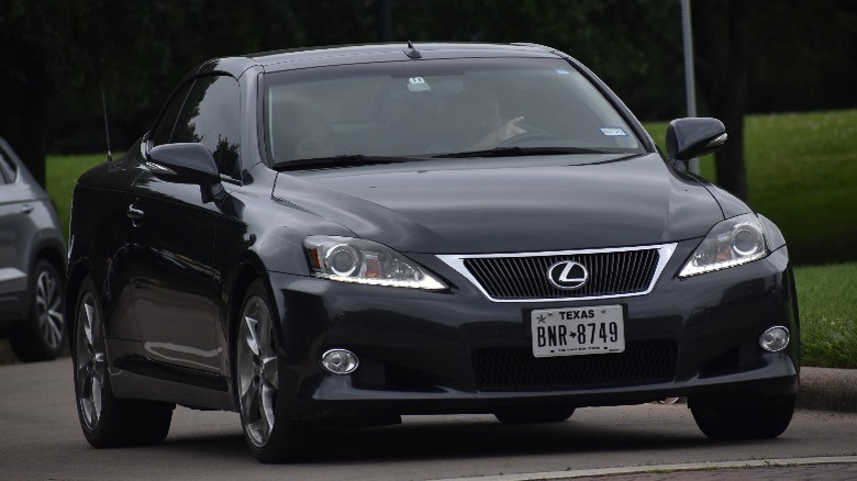 black Lexus ES sedan cruising down a road