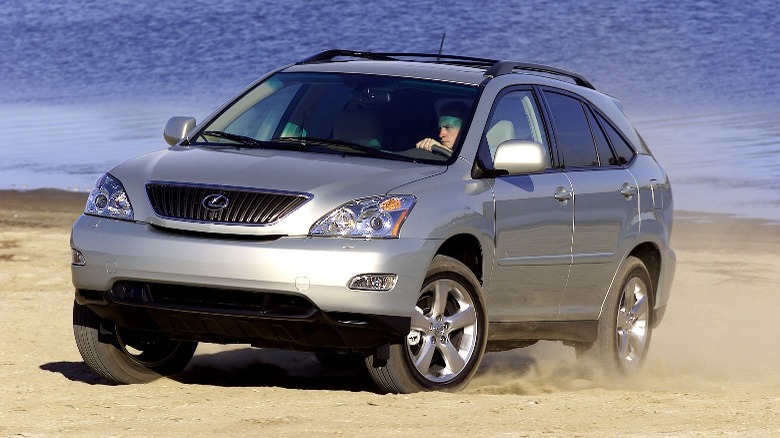 a silver Lexus RX330 driving on the beach