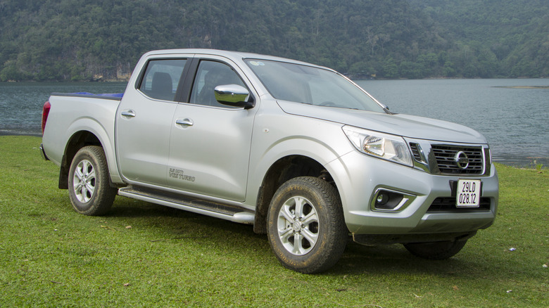 Silver Nissan Frontier on lakeside