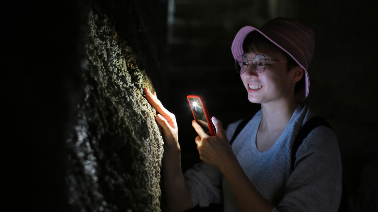 Man using phone flashlight for light