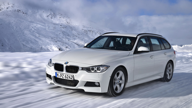 An F31 BMW 320d xDrive on the snow, front 3/4 view, white exterior