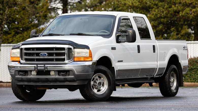 A first generation Ford Super Duty in white, front 3/4 view