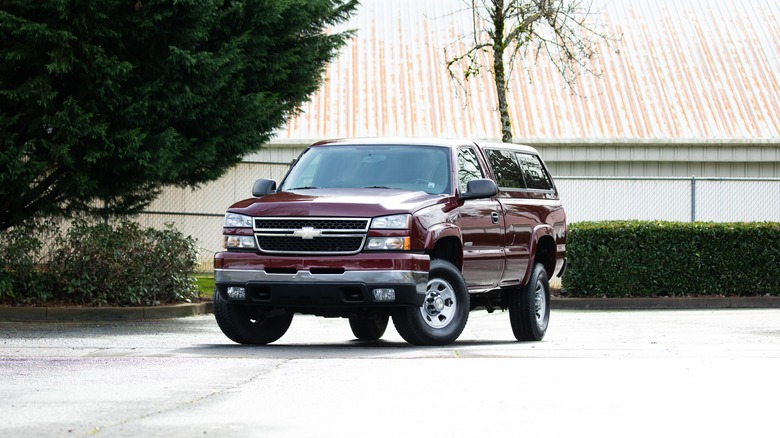 A Chevrolet Silverado HD in burgundy with a hardtop, front 3/4 view