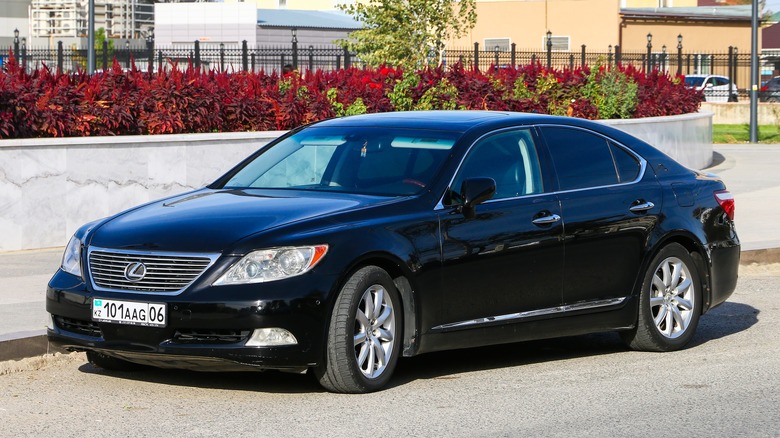 A black Lexus LS460 with smaller wheels, front 3/4 view