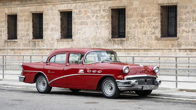 A 1956 Buick Special waiting for a taxi fare in havana.