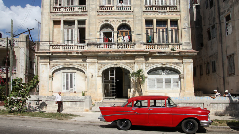 A red, 1957 Chevrolet Bel-Air Cuba parked outside a building in Havana.