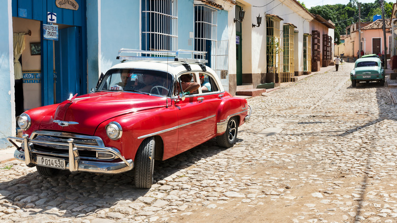 A red Chrysler New Yorker deluxe taxi in trinidad de Cuba.