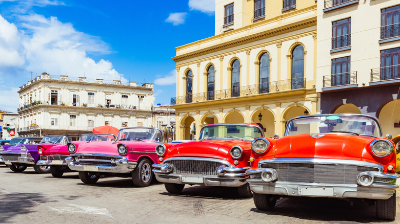 Classic American cars driving on the streets of Havana.