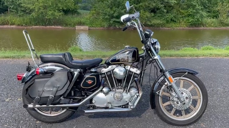 A 1978 Harley-Davidson Sportster XLH 1000 75th Anniversary model by a road-side waterbody