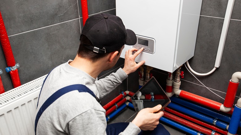 man adjusting water heater