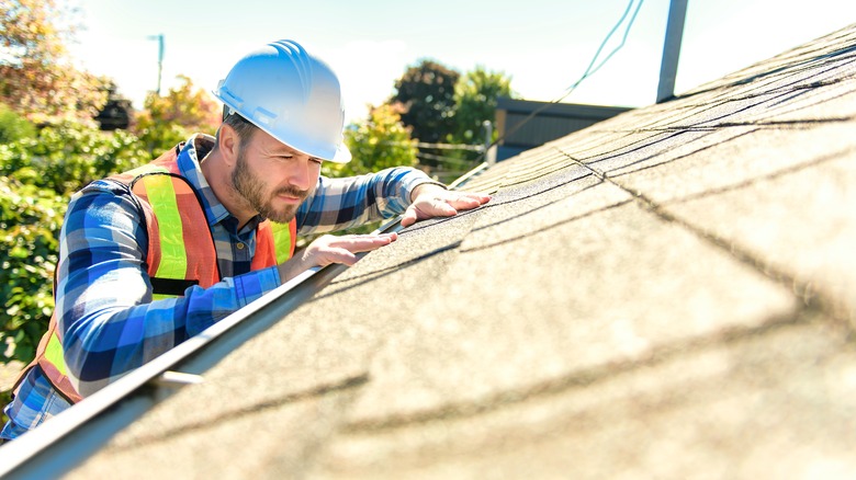 worker inspecting roof