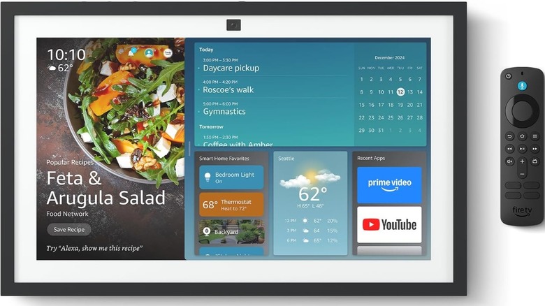 Echo Show 15 with widgets in the UI along with the Fire TV remote beside it