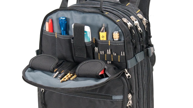 An unzipped Custom Leathercraft1132 Tool Backpack displaying tools