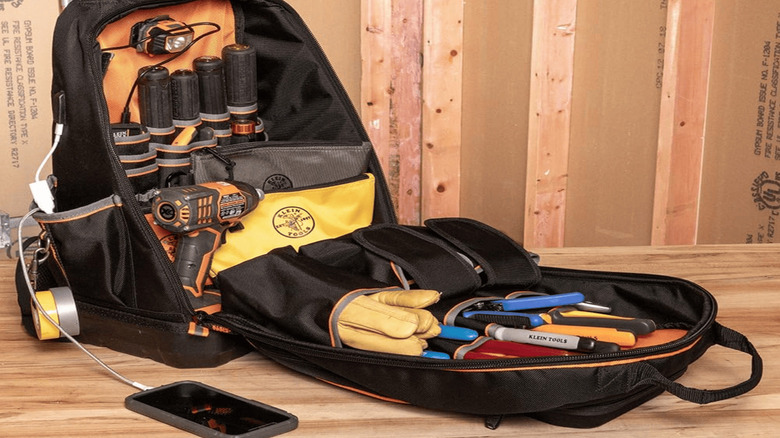 An opened Klein Tools 62800BP Backpack with several displayed tools in it