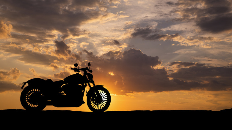 a motorcycle with sunset behind