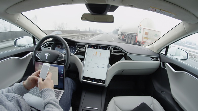 person using tesla autopilot