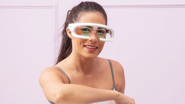 A woman wearing stress-relief glasses