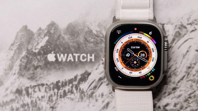 Apple Watch Ultra sitting against an image of snowy hills