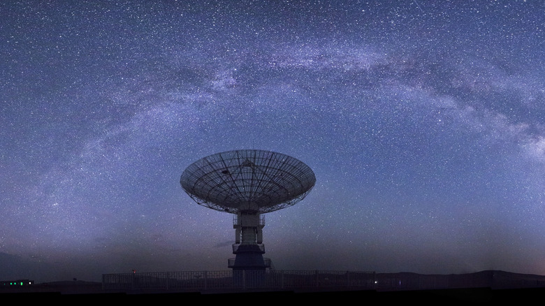 Large satellite dish in starry night